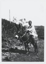 Curaçaose jongen op een ezel
