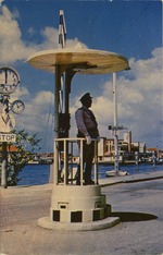 "Willemstad, Curaçao Policman directing traffic at foot of pontoon bridge, Punda side."